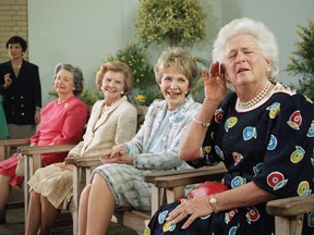 FILE - In this May 11, 1994, file photo, former first lady Barbara Bush, right, playfully strains to hear a reporter's question while posing with other former first ladies, at the U.S. Botanic Garden in Washington. Joining Barbara Bush, from left are; Lady Bird Johnson, Betty Ford and Nancy Reagan. A family spokesman said Tuesday, April 17, 2018, that former first lady Barbara Bush has died at the age of 92.