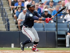 FILE - In this Friday, March 2, 2018, file photo, Atlanta Braves' Ronald Acuna watches after hitting a two-run home run during the first inning of a baseball spring exhibition game against the New York Yankees, in Tampa, Fla. Top outfield prospect Acuna is set to join the Atlanta Braves, who said they planned to promote the 20-year-old from Triple-A Gwinnett on Wednesday, April 25, 2018, to join them in Cincinnati.