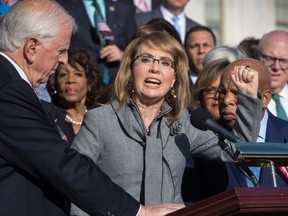 FILE - In this Wednesday, Oct. 4, 2017, file photo, former U.S. Rep. Gabby Giffords, of Arizona, who survived an assassination attempt in 2011, joins other Democrats in a call for action on gun safety legislation on the House steps at the Capitol in Washington. The FBI has released some new photos and video from its investigation of the 2011 shooting in Tucson, Ariz., that left six people dead and 13 injured, including Giffords.