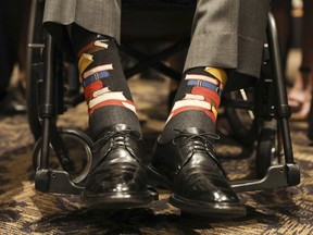 This Saturday, April 21, 2018, photo provided by the Office of former U.S. President George H.W. Bush shows Bush's socks during the funeral service for his wife, Barbara Bush, in Houston.  Barbara Bush was known for bringing awareness to AIDS patients and for her work promoting literacy, which her husband subtly honored Saturday by wearing socks printed with blue, red and yellow books.