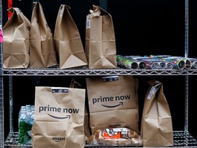 File- This Wednesday, Dec. 20, 2017, file photo, shows Amazon Prime Now bags are ready for delivery, at the Amazon warehouse in New York. Amazon says it will hike up the price of its Prime membership fee by 20 percent next month. Prime members in the U.S. will now pay $119 a year, up from $99, starting May 11 for new members. The new price will apply to renewals starting on June 16.