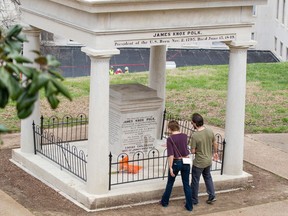 FILE - In a March 24, 2017 file photo, visitors look at the burial place of President James K. Polk and his wife, Sarah Polk, on the grounds of the state Capitol in Nashville, Tenn. The body of former president James K. Polk has been moved three times since he died of cholera in 1849, and now an effort to move it again has taken on a life of its own in the Tennessee Legislature. A much-debated resolution urging that his remains be moved to a fourth resting place appeared dead in March 2018, but was resurrected before winning final approval Monday night, April 9, 2018, in the House.