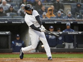 New York Yankees Giancarlo Stanton strikes out swinging in his first at-bat in the first inning of an opening day baseball game against the Tampa Bay Rays at Yankee Stadium in New York, Tuesday, April 3, 2018.