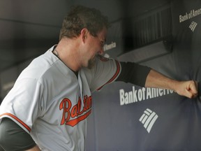 Baltimore Orioles starting pitcher Mike Wright Jr. punches a wall after allowing five runs during the first inning of a baseball game against the New York Yankees in New York, Sunday, April 8, 2018.