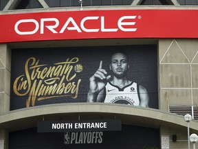 A banner depicting Golden State Warriors' Stephen Curry hangs on the exterior of Oracle Arena on Tuesday, April 10, 2018, in Oakland, Calif.