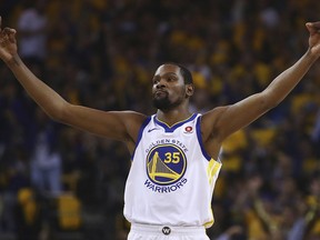 Golden State Warriors' Kevin Durant celebrates a score against the San Antonio Spurs during the first quarter in Game 5 of a first-round NBA basketball playoff series Tuesday, April 24, 2018, in Oakland, Calif.