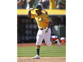 Oakland Athletics' Khris Davis celebrates after hitting a three run home run off Boston Red Sox's David Price during the eighth inning of a baseball game Sunday, April 22, 2018, in Oakland, Calif.