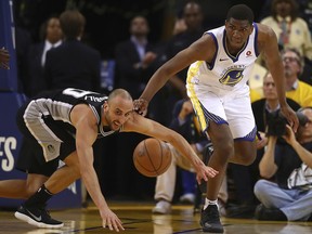 Golden State Warriors' Kevon Looney, right, and San Antonio Spurs' Manu Ginobili chase a loose ball during the fourth quarter in Game 5 of a first-round NBA basketball playoff series Tuesday, April 24, 2018, in Oakland, Calif. Golden State won 99-91.