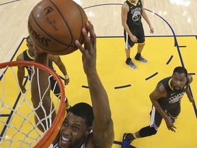 San Antonio Spurs' Rudy Gay scores against the Golden State Warriors during the first half in Game 2 of a first-round NBA basketball playoff series, Monday, April 16, 2018, in Oakland, Calif. Golden State won 116-101.