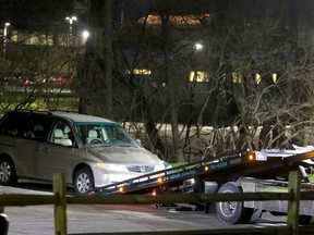 FILE - In this April 10, 2018 photo, a minivan is removed from the parking lot near the Seven Hills School campus in Cincinnati. Cincinnati officials expect to review a plan for improving the city's emergency center while police finish an internal investigation into the death of Kyle Plush who twice called 911 to report he was trapped in a minivan. The city's acting manager says he'll present City Council members Monday, April 30, with planned emergency center changes after the failed response to Plush's calls for help on April 10.