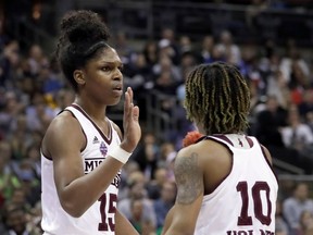 Mississippi State's Teaira McCowan, left, is congratulated by teammate Jazzmun Holmes (10) after a block during the first half against Notre Dame in the final of the women's NCAA Final Four college basketball tournament, Sunday, April 1, 2018, in Columbus, Ohio.