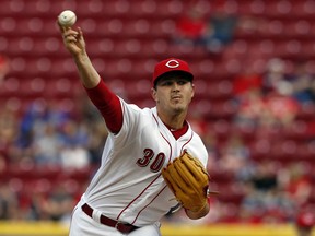 Cincinnati Reds starting pitcher Tyler Mahle throws against the St. Louis Cardinals during the first inning of a baseball game, Friday, April 13, 2018, in Cincinnati.