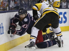 Pittsburgh Penguins' Patric Hornqvist, right, of Sweden, boards Columbus Blue Jackets' Ian Cole during the first period of an NHL hockey game Thursday, April 5, 2018, in Columbus, Ohio. Hornqvist was penalized on the play.
