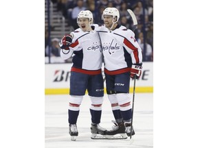 Washington Capitals' Dmitry Orlov, left, of Russia, celebrates his goal against the Columbus Blue Jackets with teammate Matt Niskanen during the first period of Game 6 of an NHL first-round hockey playoff series Monday, April 23, 2018, in Columbus, Ohio.