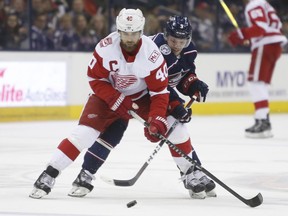 Detroit Red Wings' Henrik Zetterberg, left, of Sweden, carries the puck into the zone as Columbus Blue Jackets' Artemi Panarin, of Russia, defends during the first period of an NHL hockey game Tuesday, April 3, 2018, in Columbus, Ohio.