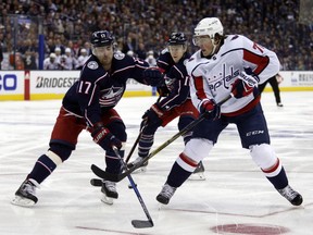 Columbus Blue Jackets forward Brandon Dubinsky, left, blocks a pass by Washington Capitals forward T.J. Oshie during the first period in Game 3 of an NHL first-round hockey playoff series in Columbus, Ohio, Tuesday, April 17, 2018.