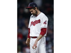 Cleveland Indians' Andrew Miller reacts after having thrown only two pitches against the Chicago Cubs during the seventh inning in a baseball game Wednesday, April 25, 2018, in Cleveland. Miller had to leave the game.