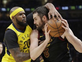 Indiana Pacers' Trevor Booker, left, puts pressure on Cleveland Cavaliers' Kevin Love in the first half of Game 5 of an NBA basketball first-round playoff series, Wednesday, April 25, 2018, in Cleveland.