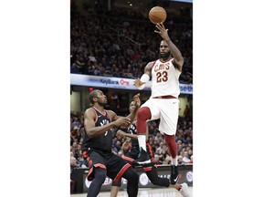 Cleveland Cavaliers' LeBron James (23) passes the ball over Toronto Raptors' Serge Ibaka (9) during the first half of an NBA basketball game Tuesday, April 3, 2018, in Cleveland.