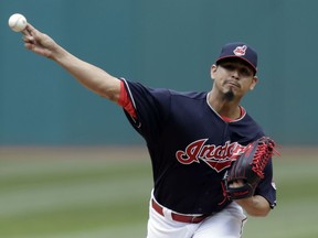 Cleveland Indians starting pitcher Carlos Carrasco delivers in the first inning of a home-opener baseball game against the Kansas City Royals, Friday, April 6, 2018, in Cleveland.