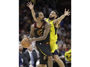 Cleveland Cavaliers' JR Smith, left, looks to pass against Indiana Pacers' Cory Joseph in the second half of Game 1 of an NBA basketball first-round playoff series, Sunday, April 15, 2018, in Cleveland. The Pacers won 98-80.