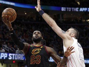 Cleveland Cavaliers' LeBron James (23) drives to the basket against Washington Wizards' Marcin Gortat (13), from Poland, in the first half of an NBA basketball game, Thursday, April 5, 2018, in Cleveland.
