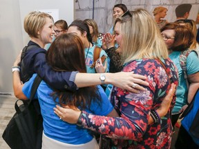 CORRECTS DATE - Carri Hicks, a fourth grade teacher at Grove Valley Elementary School, gets a hug from other Grove Valley teachers after filing for Oklahoma Senate District 40 as a Democrat during candidate filing at the Oklahoma state Capitol in Oklahoma City on Wednesday, April 11, 2018.