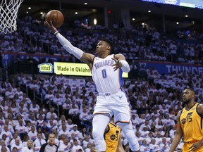 Oklahoma City Thunder guard Russell Westbrook (0) shoots in front of Utah Jazz guard Ricky Rubio (3) and forward Derrick Favors (15) during the first half of Game 2 of an NBA basketball first-round playoff series in Oklahoma City, Wednesday, April 18, 2018.