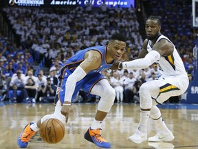 Oklahoma City Thunder guard Russell Westbrook, left, reaches for the ball in front of Utah Jazz forward Jae Crowder during the first half of Game 5 of an NBA basketball first-round playoff series in Oklahoma City, Wednesday, April 25, 2018.