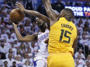 Oklahoma City Thunder forward Corey Brewer, left, shoots as Utah Jazz forward Derrick Favors (15) defends during the first half of Game 2 of an NBA basketball first-round playoff series in Oklahoma City, Wednesday, April 18, 2018.