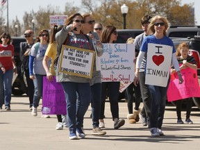Teachers and supporters walk around the state Capitol, Monday, April 9, 2018, in Oklahoma City, as protests continue over school funding.