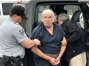 Ronnie Dean Busick arrives at the Craig County Jail in Vinita, Okla., on Wednesday, April 25, 2018.  Busick was charged Monday with four counts of first-degree murder in the killing of Danny and Kathy Freeman of Craig County, and the disappearance of teenagers Lauria Bible and Ashley Freeman. Oklahoma officials say two other suspects have died.