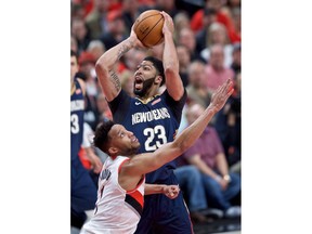 New Orleans Pelicans forward Anthony Davis shoots over Portland Trail Blazers forward Evan Turner during the first half of Game 2 of an NBA basketball first-round playoff series Tuesday, April 17, 2018, in Portland, Ore.