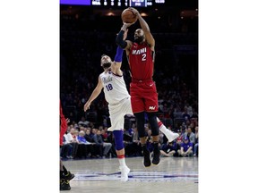 Miami Heat's Wayne Ellington, right, shoots with Philadelphia 76ers' Marco Belinelli, left, of Italy, defending during the first half in Game 2 of a first-round NBA basketball playoff series, Monday, April 16, 2018, in Philadelphia.