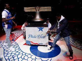 CORRECTS TO MEEK MILL NOT MEEK MILLS Rapper Meek Mill, left, comes out to ring a Liberty Bell replica with actor Kevin Hart, right, before the first half in Game 5 of a first-round NBA basketball playoff series between the Miami Heat and the Philadelphia 76ers, Tuesday, April 24, 2018, in Philadelphia.