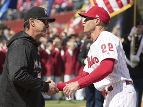 Miami Marlins manager Don Mattingly, left, shakes hands with Philadelphia Phillies manager Gabe Kapler, right, prior to the first inning of a baseball game, Thursday, April 5, 2018, in Philadelphia.