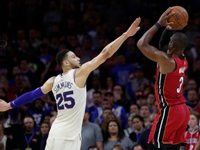 Miami Heat's Dwyane Wade, right, shoots with Philadelphia 76ers' Ben Simmons, left, of Australia, defending during the second half in Game 2 of a first-round NBA basketball playoff series, Monday, April 16, 2018, in Philadelphia. The Heat won 113-103.