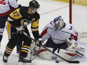 Pittsburgh Penguins' Sidney Crosby (87) can't get his stick on a rebound off Washington Capitals goaltender Philipp Grubauer (31) in the first period of an NHL hockey game in Pittsburgh, Sunday, April 1, 2018.