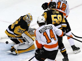 A shot by Philadelphia Flyers' Shayne Gostisbehere gets through the pads of Pittsburgh Penguins goaltender Matt Murray (30) with Flyers' Nolan Patrick (19) providing a screen during the first period in Game 2 of an NHL first-round hockey playoff series against the in Pittsburgh, Friday, April 13, 2018.