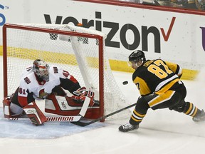 Ottawa Senators goaltender Craig Anderson (41) makes a save on Pittsburgh Penguins' Sidney Crosby (87) during the first period of an NHL hockey game Friday, April 6, 2018, in Pittsburgh.