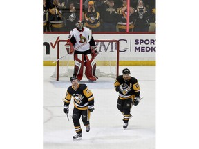 Pittsburgh Penguins' Patric Hornqvist (72) skates off the ice with Sidney Crosby (87) after scoring on Ottawa Senators goaltender Craig Anderson (41) during the third period of an NHL hockey game Friday, April 6, 2018, in Pittsburgh. The Penguins won 4-0.