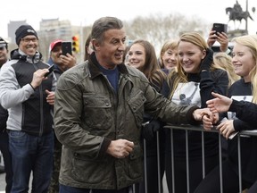 Sylvester Stallone greets a crowd as he walks to the Rocky statue at the Philadelphia Art Museum for a photo op with Philadelphia Mayor Jim Kenney to promote "Creed II," Friday, April 6, 2018, in Philadelphia. The film, part of the "Rocky" film franchise, will be released later this year.
