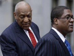 Bill Cosby, left, arrives for a pretrial hearing in his sexual assault case, Friday, March 30, 2018, at the Montgomery County Courthouse in Norristown, Pa.
