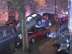 This still image taken from video shows vehicles damaged by an out-of-control trash truck on Wednesday, April 4, 2018, in Philadelphia. The out-of-control trash truck smashed into a row of parked cars along a residential street in Philadelphia, but no injuries have been reported.