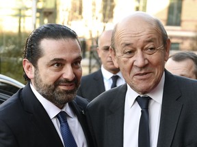 Lebanese Prime Minister Saad Hariri, left, is welcomed by France's Foreign Minister Jean-Yves Le Drian before the international CEDRE conference in Paris Friday, April 6, 2018.France is holding an international conference devoted to debt-ridden Lebanon to bring in funds and lay groundwork to ensure money is well spent.