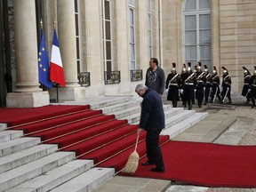 A man wipes the red carpet before Saudi Arabia Crown Prince Mohammed bin Salman's arrival at the Elysee Palace in Paris, Tuesday, April 10, 2018. France is tapping into the business of culture to develop agreements with Saudi Arabia and profit from the heir to the throne's goal of modernizing the conservative kingdom.