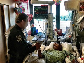 Broward County Sheriff Scott Israel holds the hand of 15-year-old Parkland survivor Anthony Borges on Feb. 18.