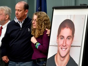 FILE – In this May 5, 2017, file photo, Jim and Evelyn Piazza, center, stand by as Centre County, Pa., prosecutors discuss an investigation into the death of their son Timothy Piazza, seen in photo at right, during a news conference in Bellefonte, Pa. Criminal penalties for hazing would become more severe under a bill approved unanimously Wednesday, April 18, 2018, by the Pennsylvania Senate, inspired by the Feb. 4, 2017, death of 19-year-old pledge Timothy Piazza, of Lebanon, N.J., after a night of heavy drinking.