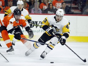 Philadelphia Flyers' Ivan Provorov, left, and Pittsburgh Penguins' Conor Sheary, chase the puck during the first period in Game 3 of an NHL first-round hockey playoff series Sunday, April 15, 2018, in Philadelphia, Pa.