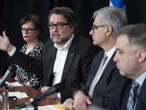 Quebec ministers Lucie Charlebois, David Heurtel, Jean-Marc Fournier and Sebastien Proulx, left to right, discuss the situation involving asylum seekers during a news conference, Monday, April 16, 2018 in Montreal.